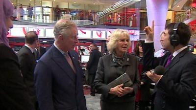 Presenter Ros Atkins talking to Prince Charles and Camilla on visit to New Broadcasting House