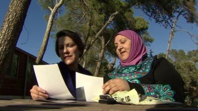 Ruth Ebenstein and Ibtisam Erekat look at photographs