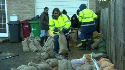 Volunteers filling sandbags