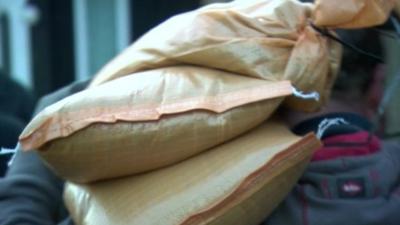 Man carrying sandbags on shoulder