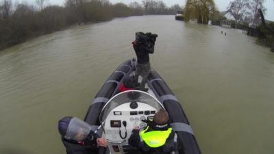 Boat with BBC crew on flood water