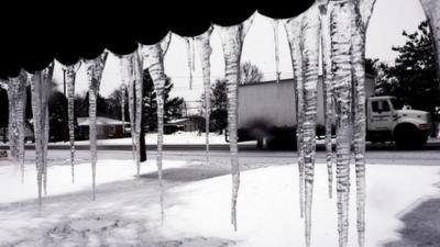 Icicles dangle from the metal awning at a home during a snow storm in Lumberton, North Carolina 12 February 2014