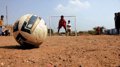 Football and boy in goal