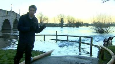 Nick Beake stood by an overflowing Thames in Chertsey