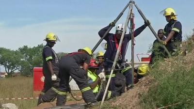 Rescue teams working at the top of the shaft on Sunday