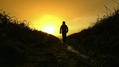 Silhouette of person walking on beach