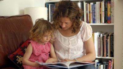 woman reading to child