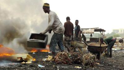 A man sorts e-waste in Agbogbloshie, Ghana
