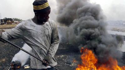 A man sorts e-waste in Agbogbloshie, Ghana