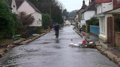 Man walking down flooded street