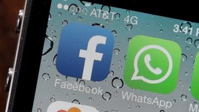 Facebook and WhatsApp icons on a smartphone