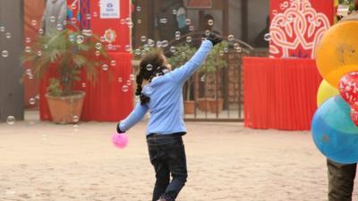 Girl playing with bubbles in Delhi