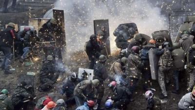 Protesters sheltering behind shields