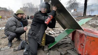 Anti-government protesters take cover