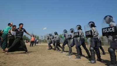 People throw water bottles at riot control policemen during a European Union (EU) crowd management training session