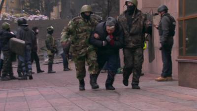 An injured protester is taken away in Kiev