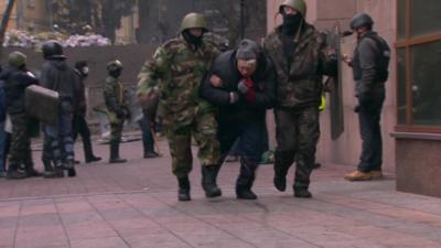 An injured protester is taken away in Kiev