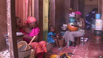 Dakar tenants sharing a hallway as a kitchen