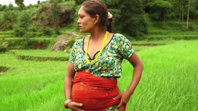 Pregnant woman in a field in Nepal