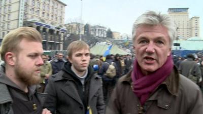 Tim Willcox with opposition protesters