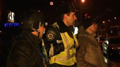 Members of a vigilante group assist traffic police in Kiev