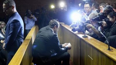 Oscar Pistorius surrounded by cameras in court