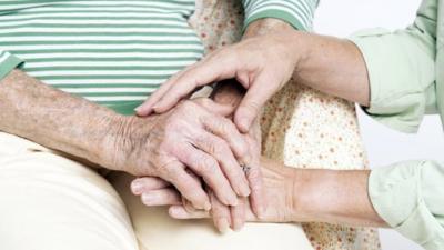 Woman being comforted by carer