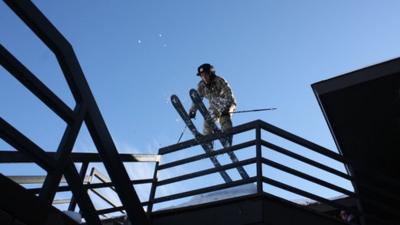 Sandy Boville skiing off a balcony railing in St Paul, Minnesota