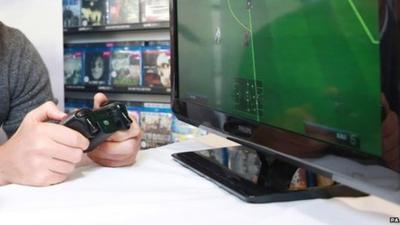 Person playing FIFA 14