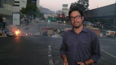 The BBC's Vladimir Hernandez in front of a barricade