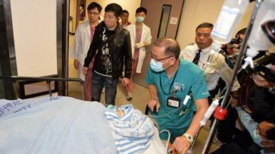 Former Ming Pao chief editor Kevin Lau is taken to an operation room in a hospital in Hong Kong, 26 February 2014