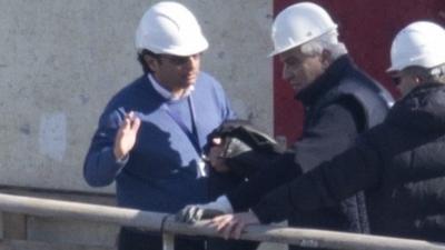 Captain Francesco Schettino, left, talks on the upper deck of the wreck of the Costa Concordia cruise ship