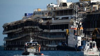 A small boat on his way to visit the wrecked Costa Concordia cruise ship