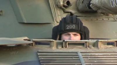 Russian soldier peering out of tank