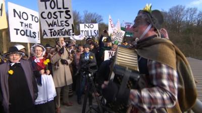 Protesters on a bridge over the M48 close to the toll booths