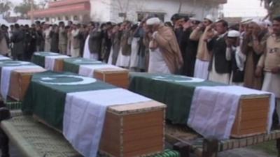 Coffins draped in the Pakistani flag