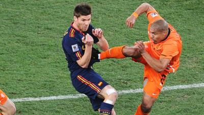 Nigel de Jong puts in a high tackle on Xabi Alonso