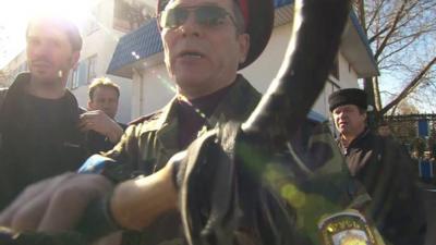 Russian soldier pushing whip into camera