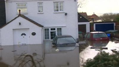 Flooded homes and submerged cars