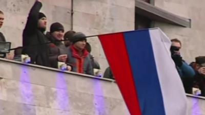 A Russian flag being waved on a government building