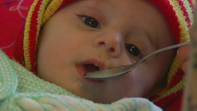 Baby being spoon fed