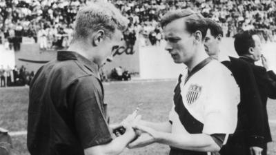 England's Billy Wright and USA's Ed McIlvenny exchange souvenirs before the match
