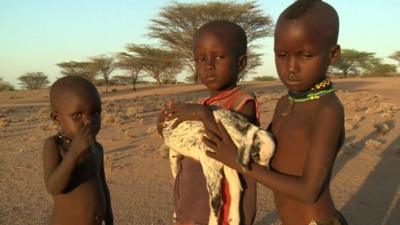 Children with lifeless goat