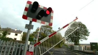 Railway crossing red light and barrier