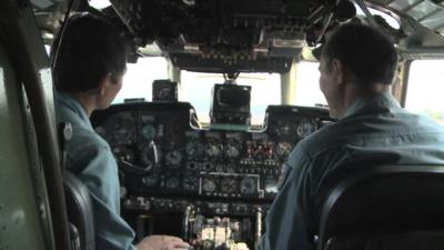 Vietnamese search and rescue crew in plane cockpit