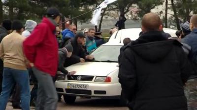 Pro-Russian crowds attack a car with Ukrainian activists in Sevastopol