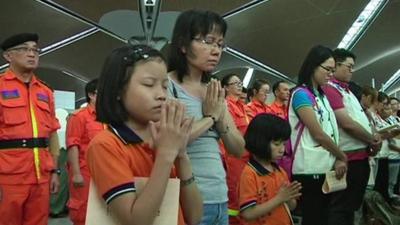 Family and airport staff praying