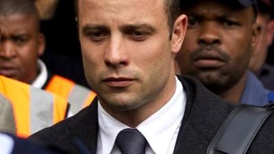 Oscar Pistorius, centre, leaves the high court in Pretoria, South Africa, on 11 March