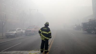 A firefighter surrounded by smoke