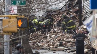 Firefighters dig through rubble